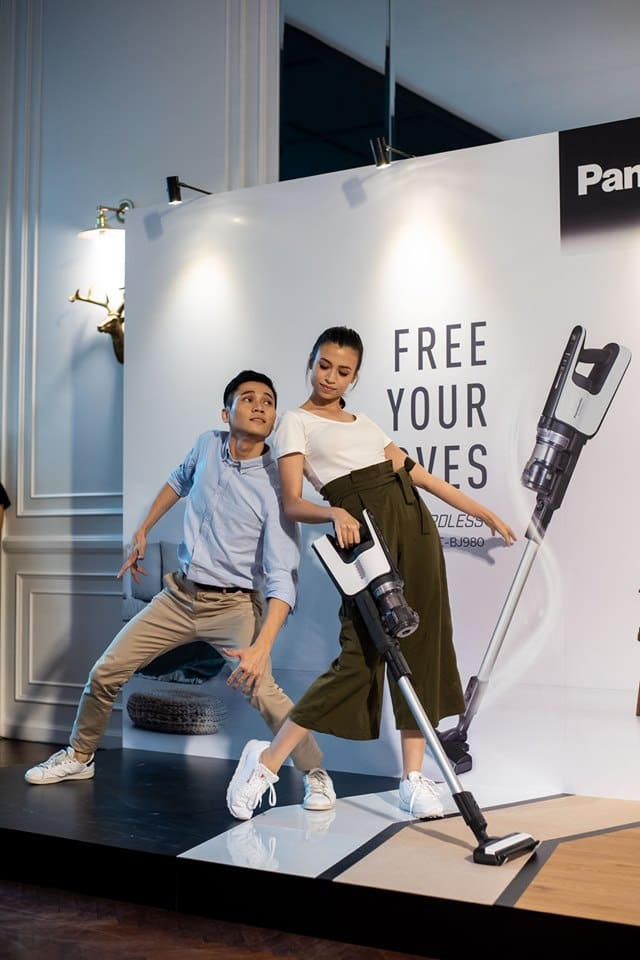 A man and a woman in the middle of a dance performance in front of Panasonic’s backdrop with the tagline “Free Your Moves” at our event space in KL
