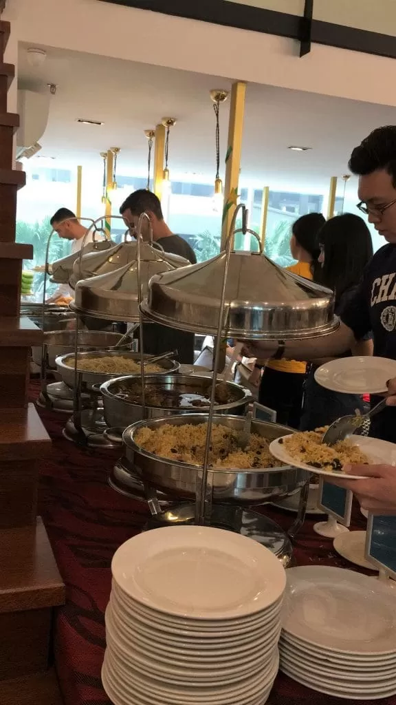 A selection of traditional Malay food at a buffet in Colony's event space KL. Guests are taking their portion of their food.
